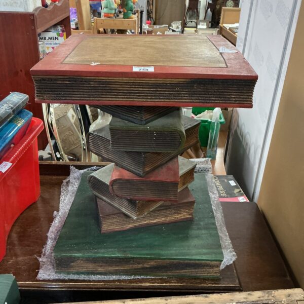 Stacked vintage books forming a unique coffee table.