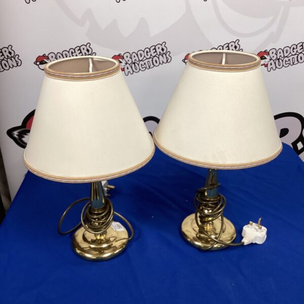 Pair of vintage brass table lamps with cream shades.