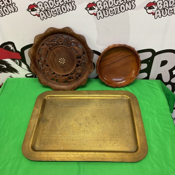Vintage engraved brass serving tray with wooden bowls.