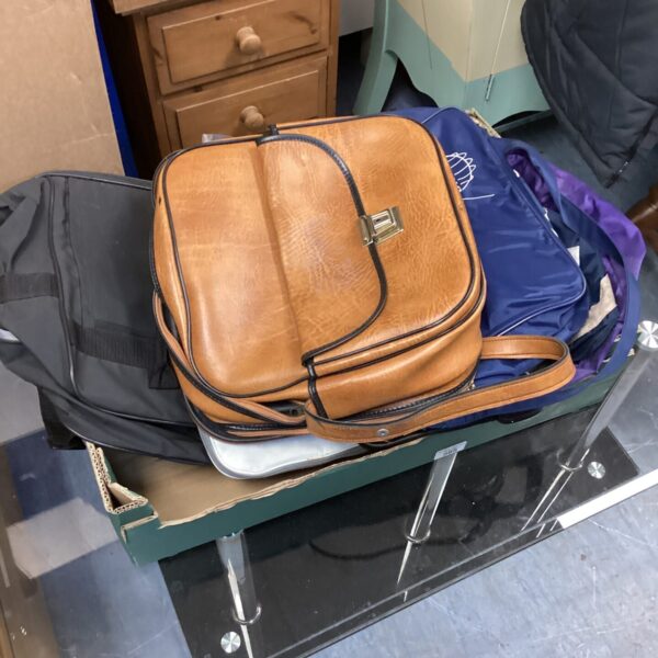 Vintage brown leather shoulder bag with adjustable strap.