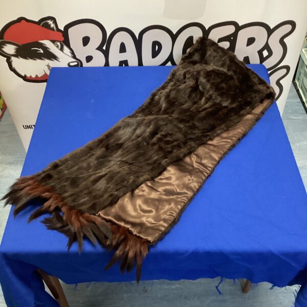 Vintage brown mink fur stole draped on a surface.