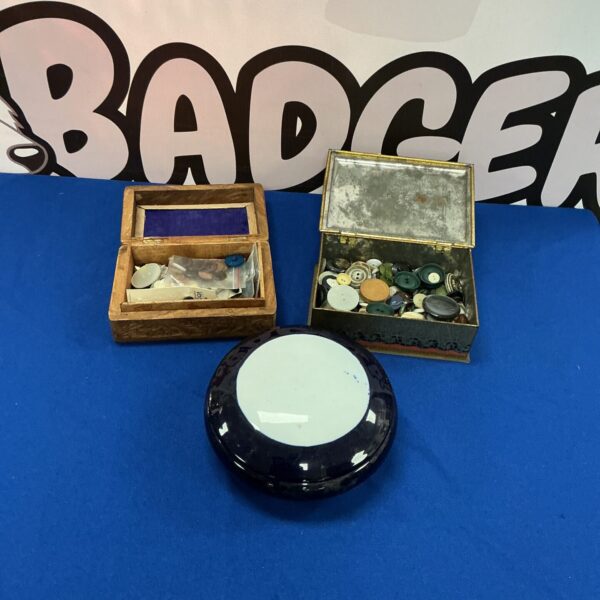 Close-up of two wooden boxes filled with vintage buttons.