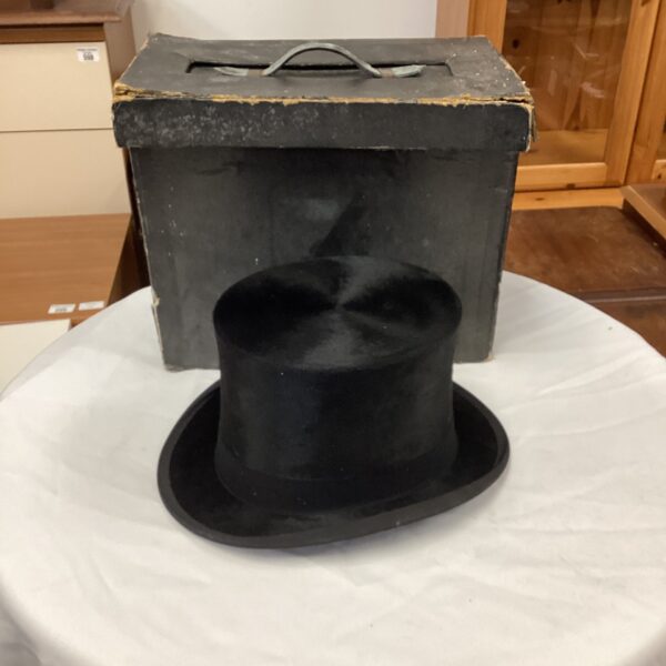 Black vintage Carswell top hat on display.