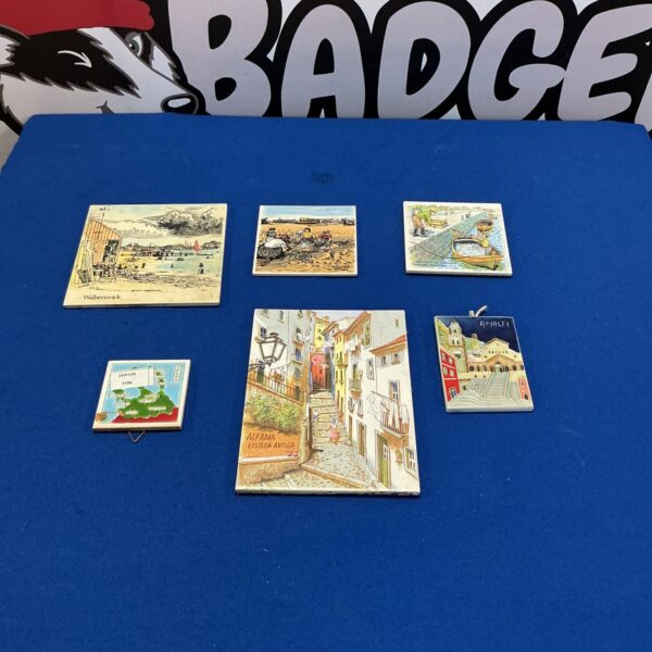 Vintage Portuguese ceramic tiles with detailed scenes and patterns.