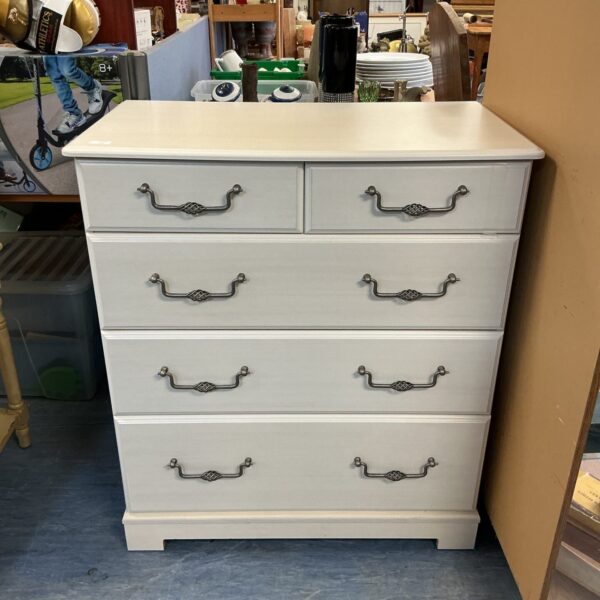 Vintage wooden chest of drawers for bedroom storage.
