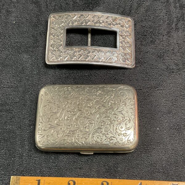 Vintage silver plate cigarette case and clover leaf belt buckle set.