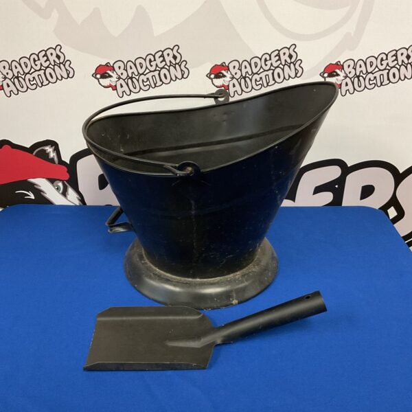 Vintage metal coal scuttle with shovel for fireplace use.