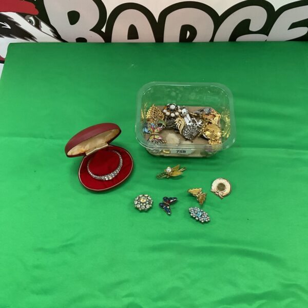 Tray of vintage costume jewellery including brooches and a bracelet.