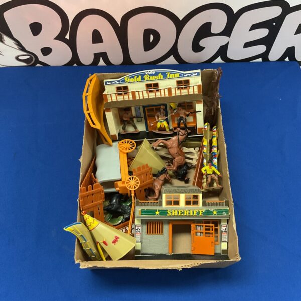 Vintage Cowboys and Indians playset with figures and building.