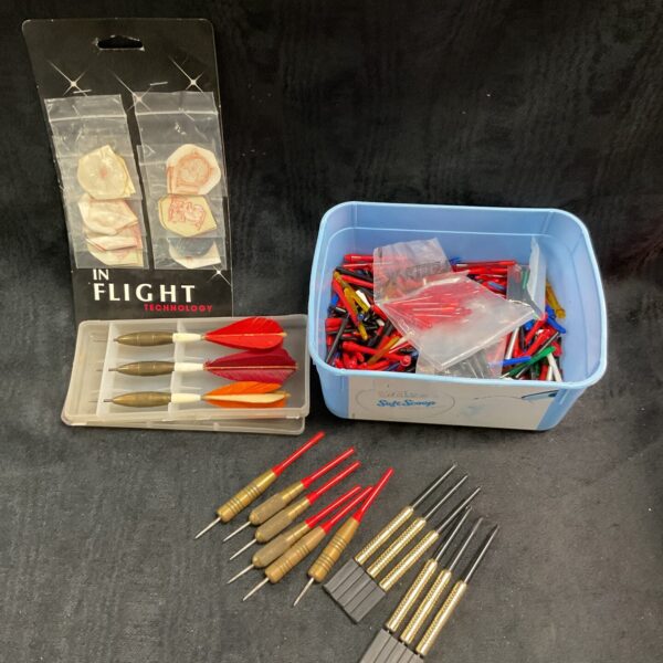 Vintage dart collection in a plastic tub, including flights and stems.
