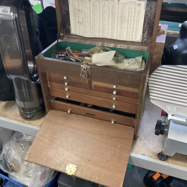 Vintage wooden engineer's storage cabinet with drawers open.