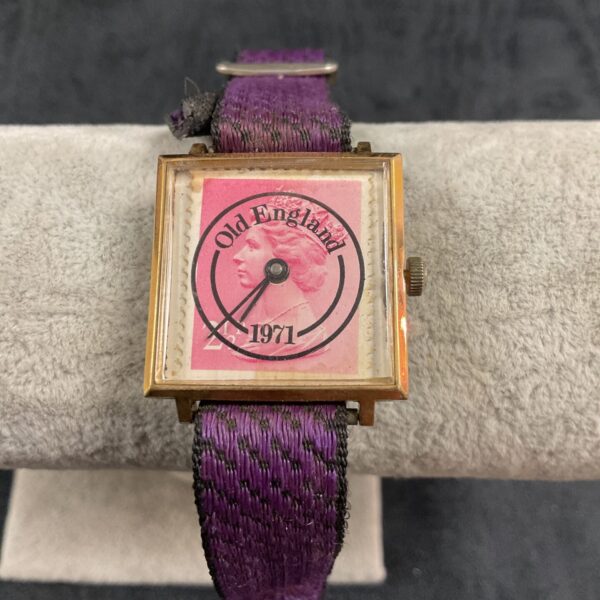 Vintage England square wrist watch with purple fabric strap.