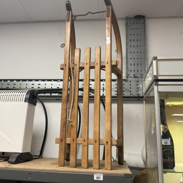 Vintage wooden Erbacher Davos snow sled for winter recreation.