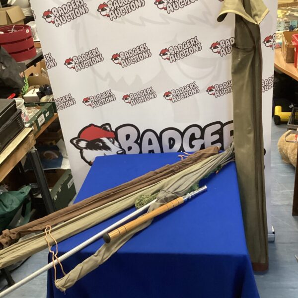 Vintage fishing rods bundle with nets and bag for collectors.