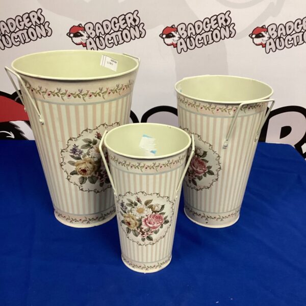 Set of three vintage floral patterned metal paper bins.