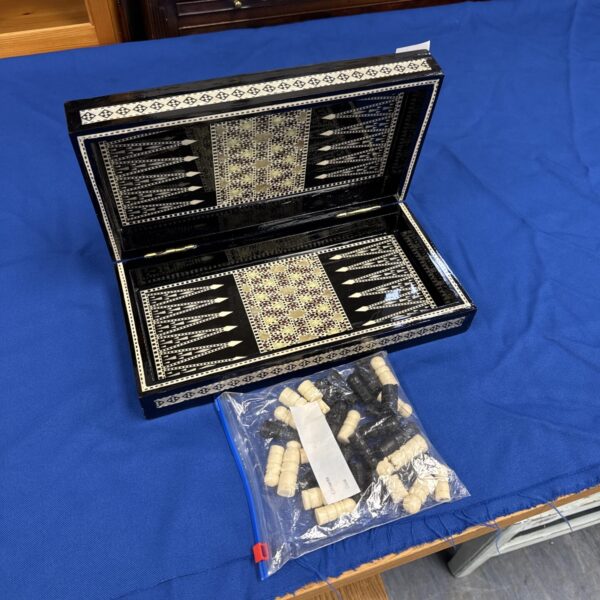 Vintage folding backgammon set with inlaid geometric pattern.