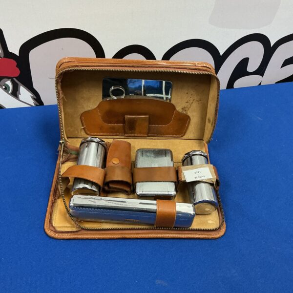 Vintage gentleman’s shaving kit in a brown leather case.