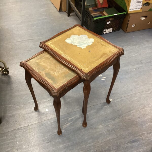 Vintage nest of tables with glass tops and wooden frames.