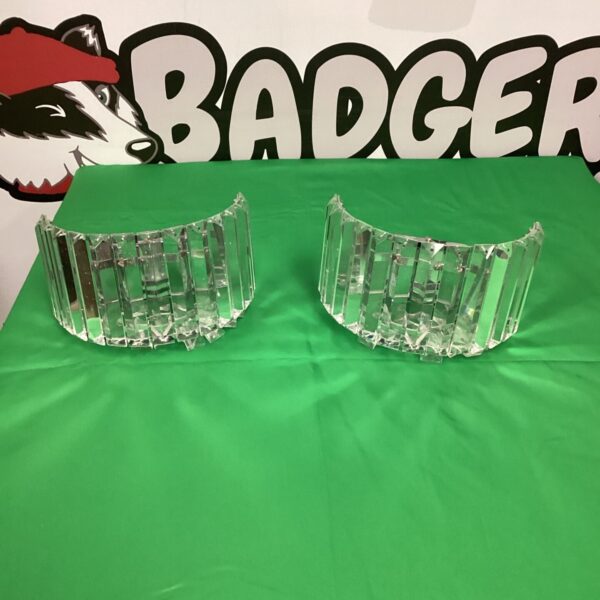 Clear glass wall sconces with geometric faceted design.