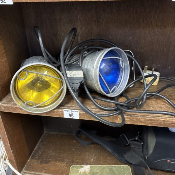 Pair of vintage industrial spotlights with metal housings.