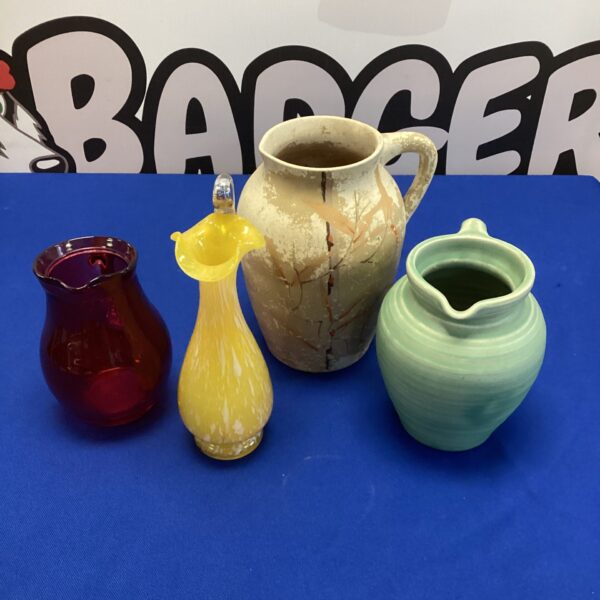 Vintage jugs collection featuring cranberry and yellow glass.