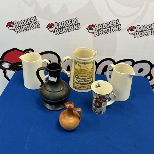 Vintage stoneware jugs featuring Shepperds Neames Ale brewery mark.