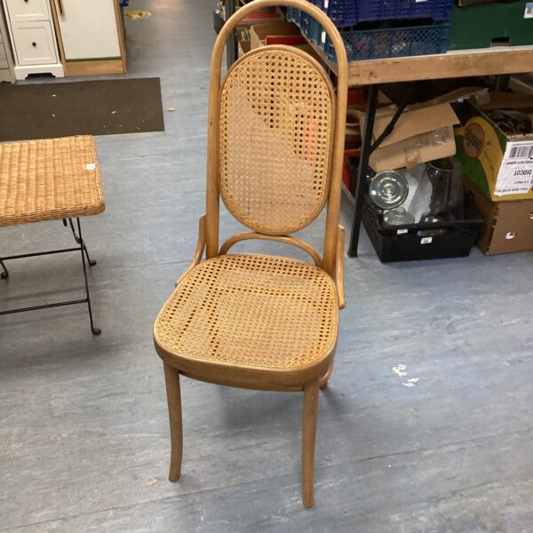 Vintage Kane dining chair with woven cane back.