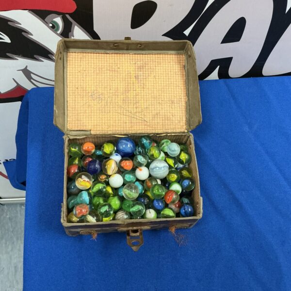 Vintage marble collection in a worn leather box.