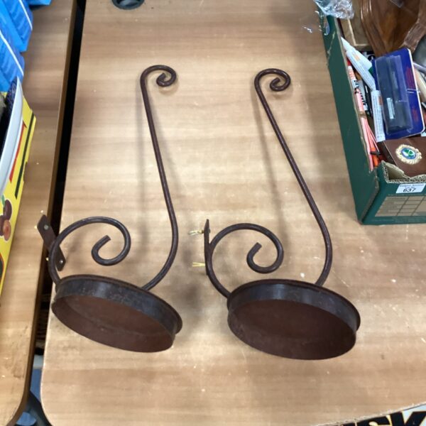 Two vintage metal plant hangers with dark iron finish.