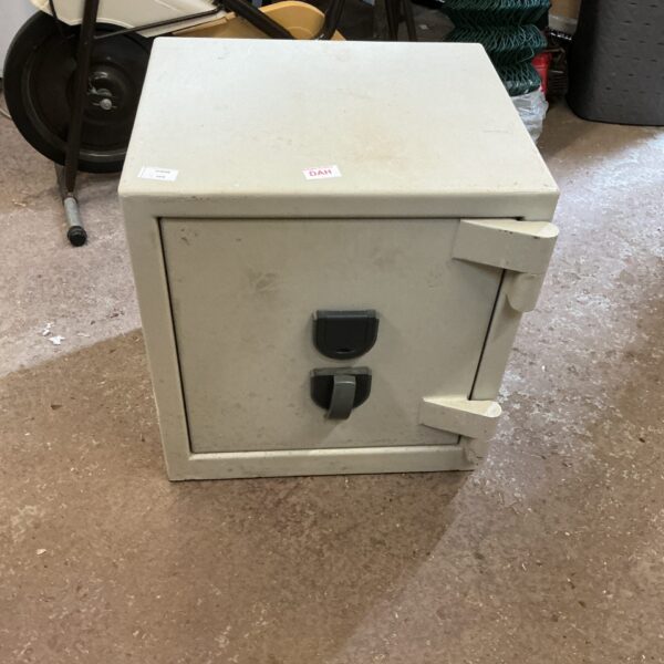 Vintage metal secure safe with keyhole, ideal for storage.