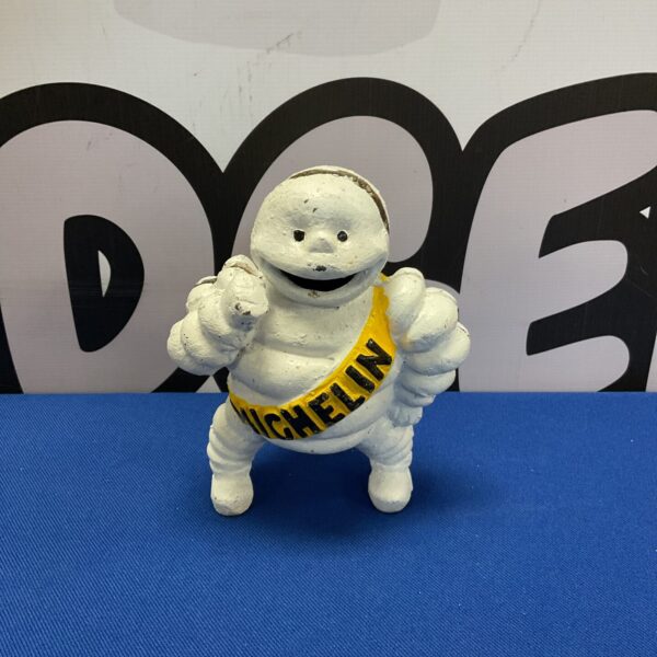 Front view of vintage cast iron Michelin Man money box.