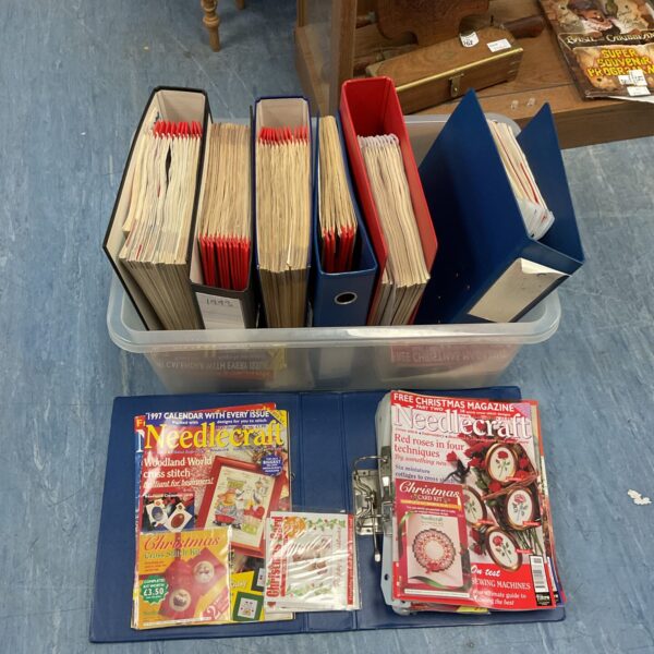 Collection of vintage needlecraft magazines in binders.