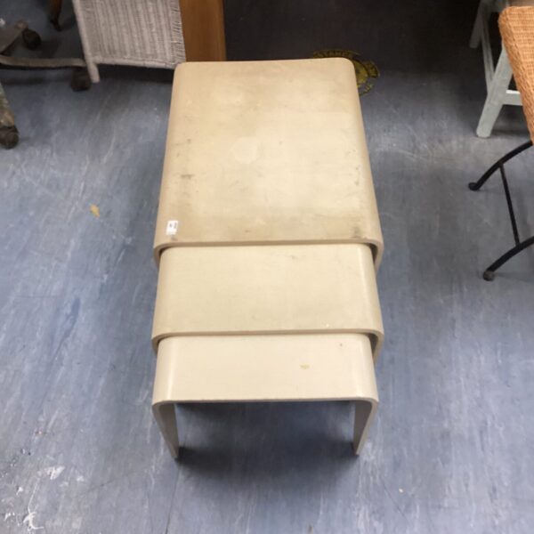 Vintage 1970s nest of tables with a light wood veneer.