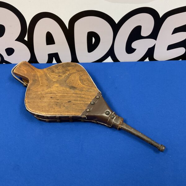 Vintage oak fireplace bellows with leather nozzle and patterned fabric.