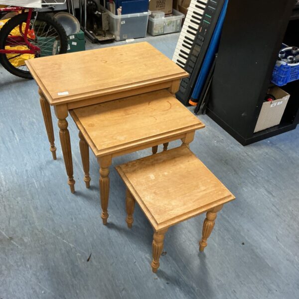 Vintage oak nest of tables in a home setting.