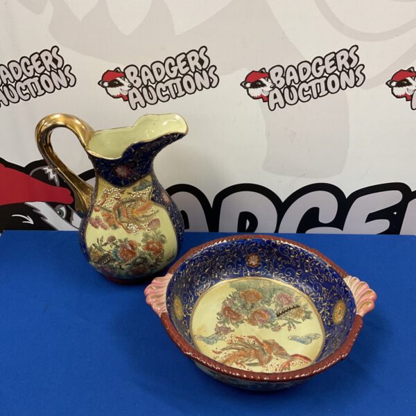 Vintage oriental jug and bowl with hand painted floral designs.