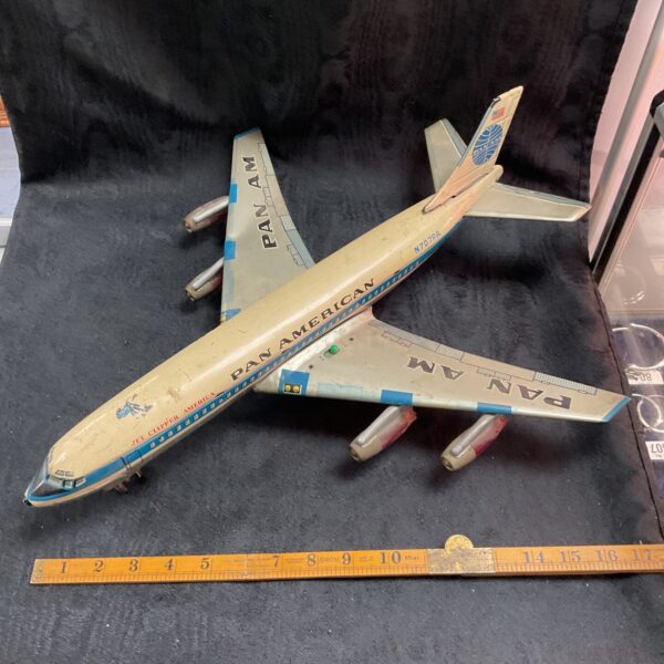 Vintage Pan Am Boeing 707 tin toy plane, side view.