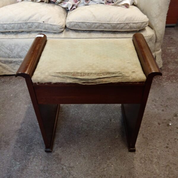 Vintage wooden piano stool with patterned seat.