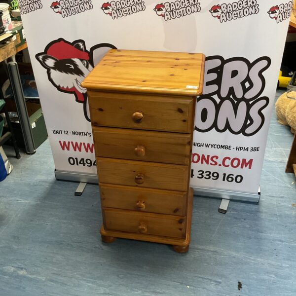 Vintage pine chest of drawers with multiple drawers for bedroom storage.