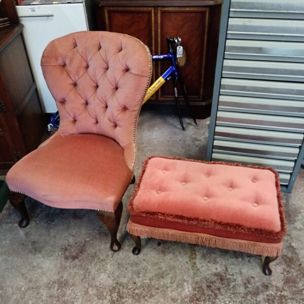Vintage pink nursing chair with matching footstool, antique upholstered seating.