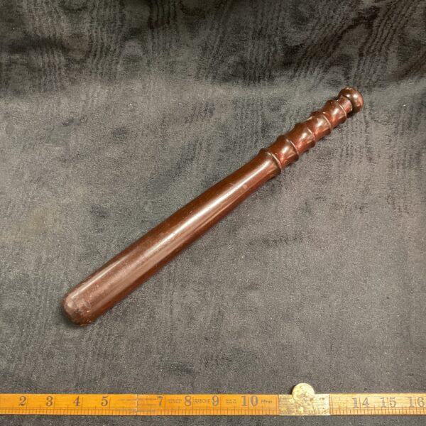 Vintage wooden police truncheon, a collectible law enforcement baton.