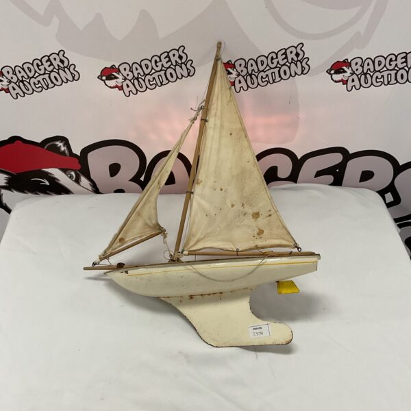 Vintage wooden pond yacht with metal rudder, collectible model boat.