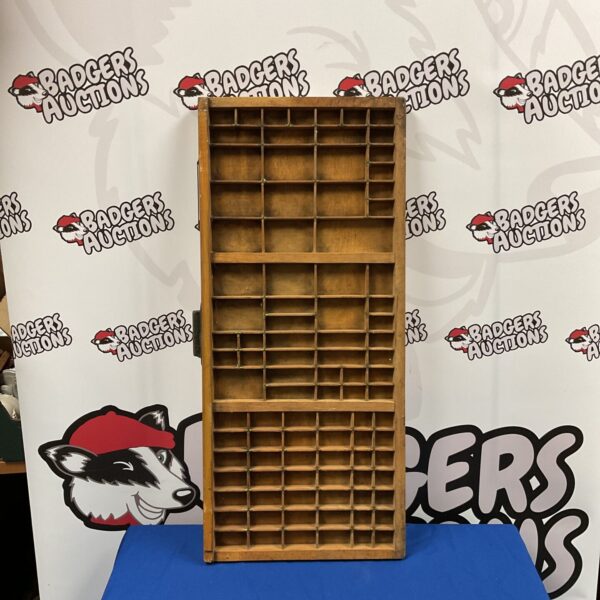 Vintage printers block tray with brass dividers for letterpress printing.