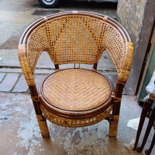 Vintage rattan chair with woven seat and back.