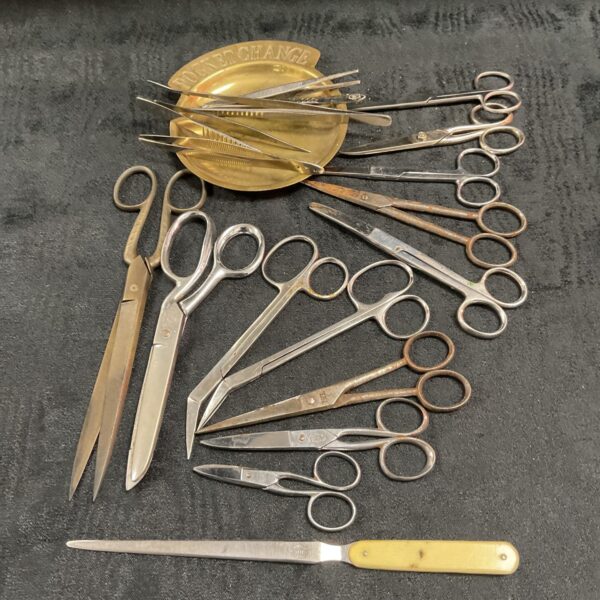 Vintage lot of scissors, tweezers and a paper knife on a dish.