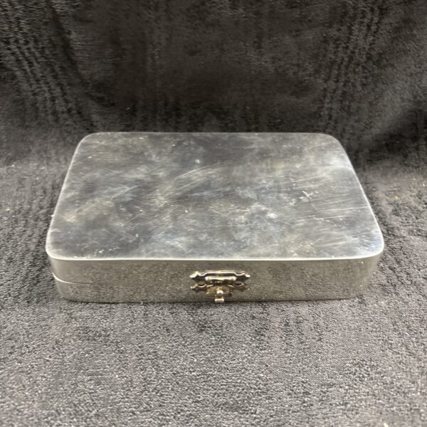 Silver tone vintage shaving case with clasp closure.