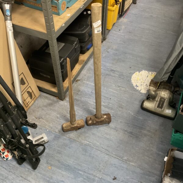 Pair of vintage sledge hammers with wooden handles.