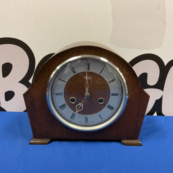 Vintage Smiths mantle clock with wooden case and clear dial.