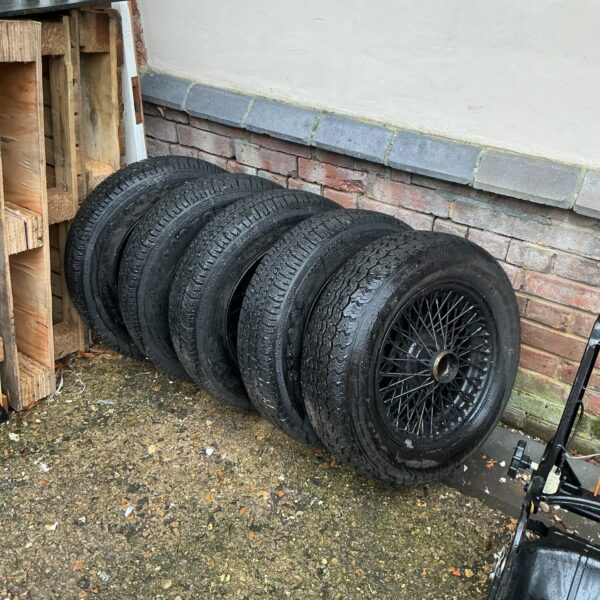 Set of vintage spoked wheels for classic car restoration.