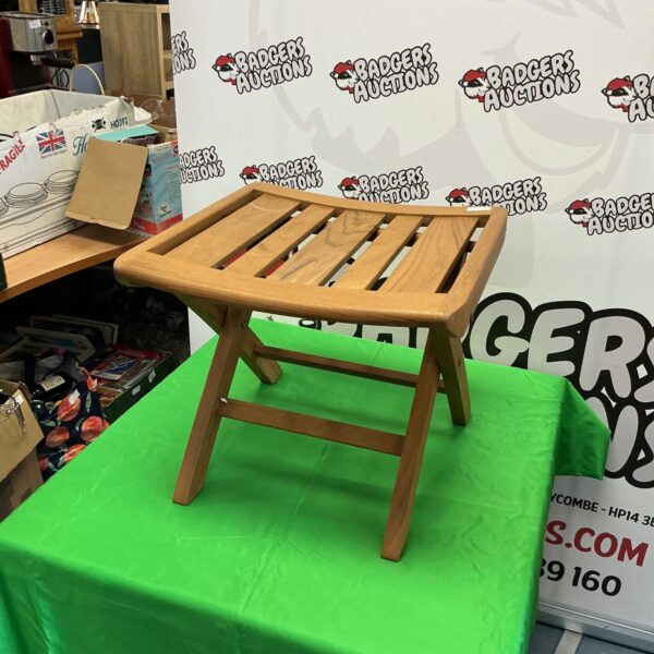 Vintage teak folding stool with a warm wood grain.